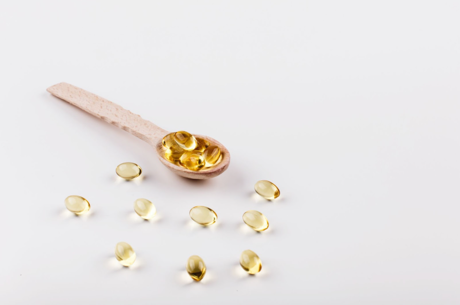 Жълти прозрачни капсули в лъжичка